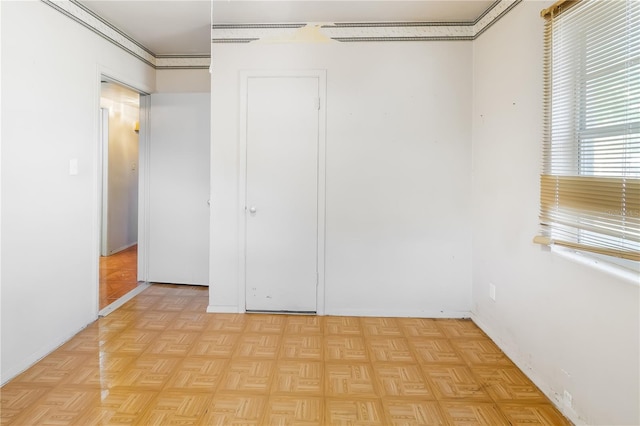 unfurnished bedroom featuring light parquet flooring