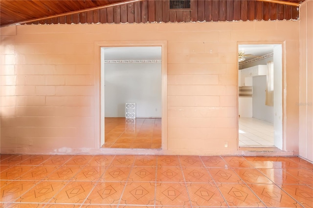 spare room with wooden ceiling and tile patterned flooring