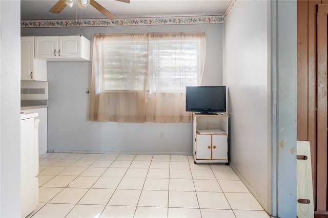 kitchen featuring ceiling fan and white cabinets