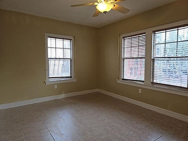 spare room featuring ceiling fan and tile floors