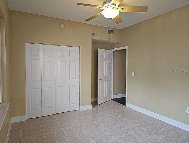 unfurnished bedroom featuring a closet, ceiling fan, and light tile floors