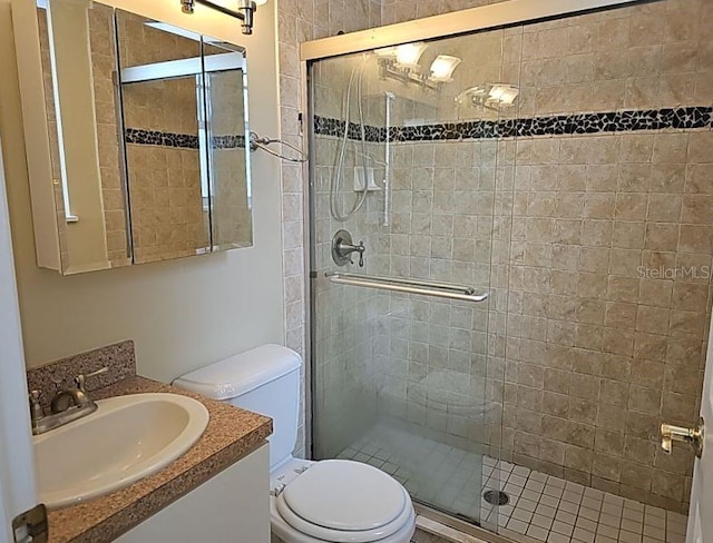 bathroom with walk in shower, vanity, and toilet