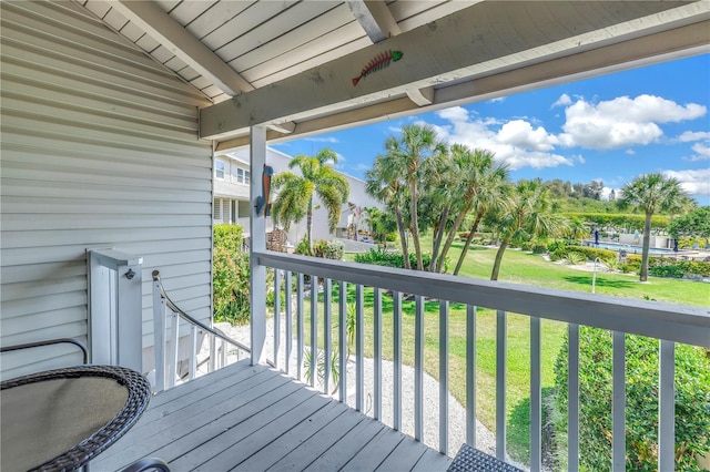 wooden deck featuring a yard