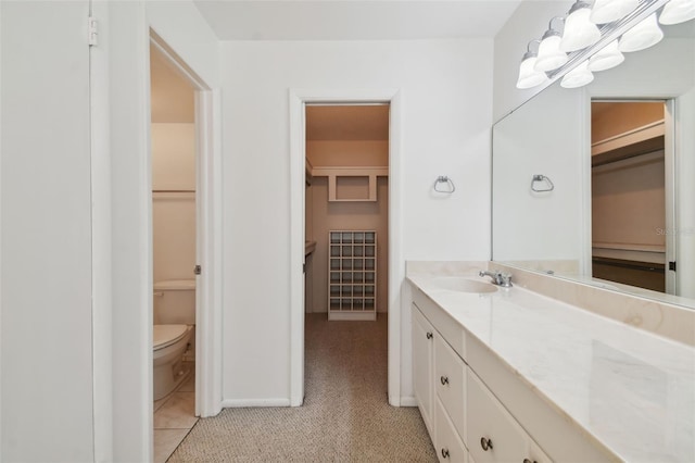 bathroom with tile flooring, oversized vanity, and toilet