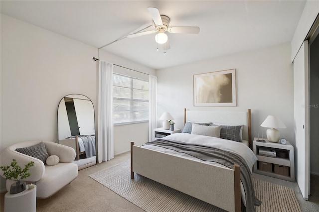 carpeted bedroom with a closet and ceiling fan