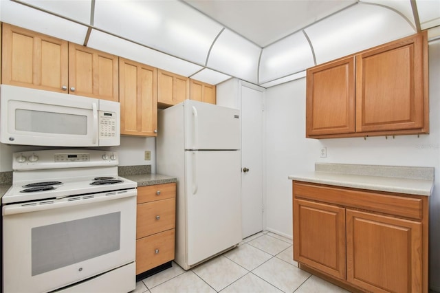 kitchen with white appliances and light tile flooring