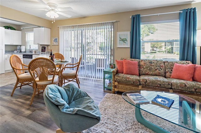 living room with hardwood / wood-style floors and ceiling fan