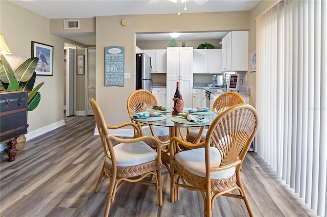 dining space featuring ceiling fan and hardwood / wood-style flooring