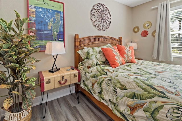 bedroom with multiple windows and hardwood / wood-style flooring