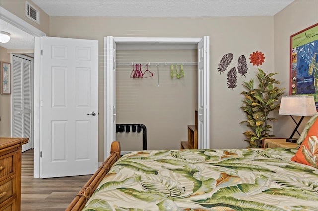 bedroom featuring a closet and hardwood / wood-style flooring