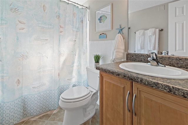 bathroom featuring toilet, tile floors, vanity, and a textured ceiling