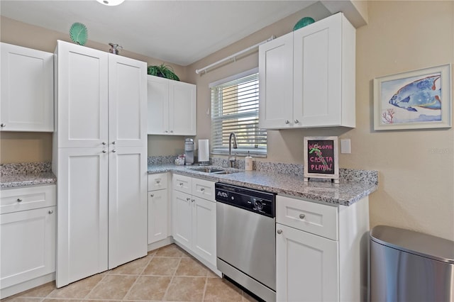 kitchen with sink, dishwasher, white cabinetry, and light tile floors