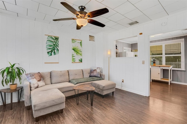 living room with ceiling fan and dark wood-type flooring