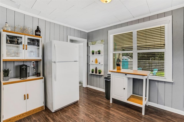 kitchen featuring white fridge and dark wood-type flooring