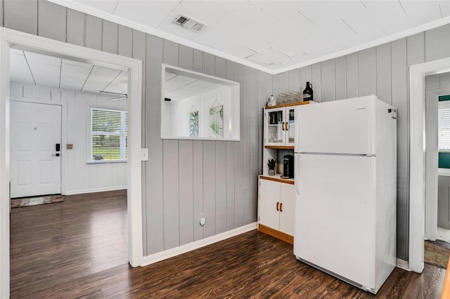 kitchen with white refrigerator, dark hardwood / wood-style flooring, and ornamental molding