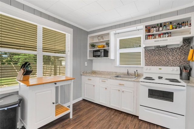 kitchen featuring white electric range, dark wood-type flooring, wall chimney range hood, white cabinets, and sink