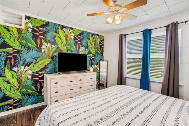 bedroom with ceiling fan, crown molding, hardwood / wood-style flooring, and multiple windows