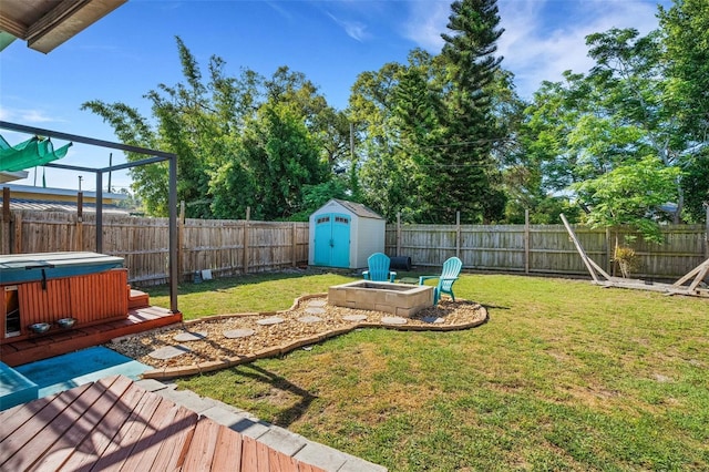 view of yard with a deck, a shed, and a hot tub