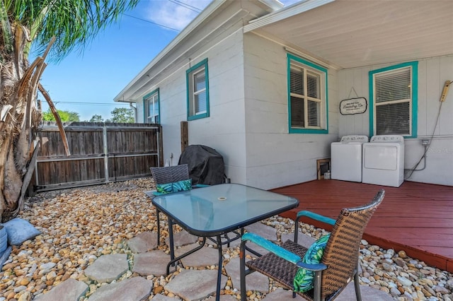 view of patio / terrace featuring a deck, a grill, and separate washer and dryer