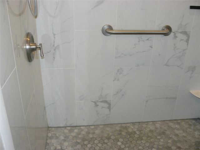 bathroom with a tile shower