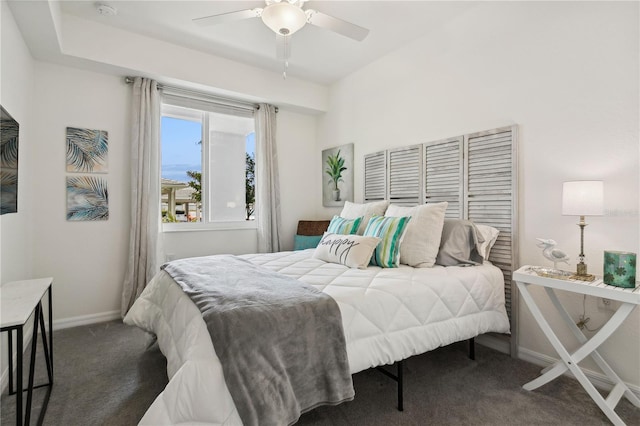 bedroom with ceiling fan, baseboards, and carpet