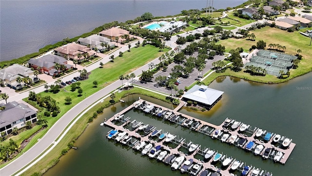 drone / aerial view featuring a residential view and a water view