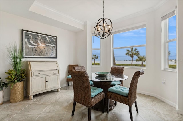 dining room featuring baseboards, a notable chandelier, and crown molding