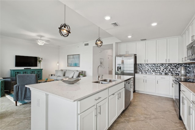 kitchen featuring a sink, stainless steel appliances, visible vents, and open floor plan