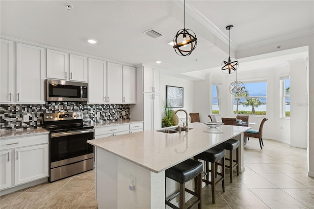 kitchen featuring visible vents, a sink, decorative backsplash, white cabinets, and appliances with stainless steel finishes