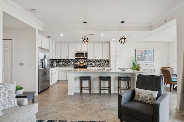 kitchen featuring open floor plan, stainless steel appliances, crown molding, and a sink