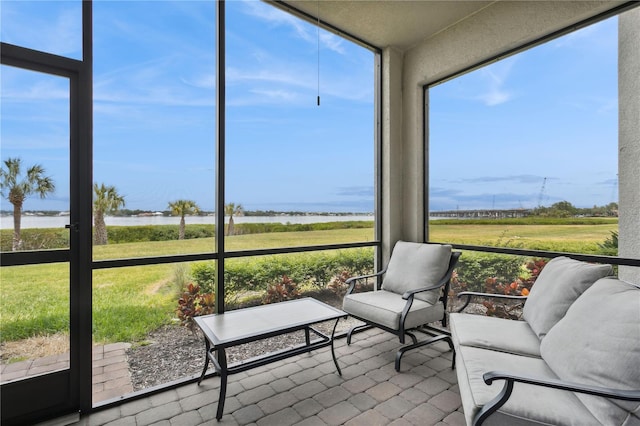 sunroom / solarium with a water view