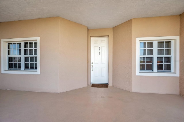 entrance to property featuring a patio