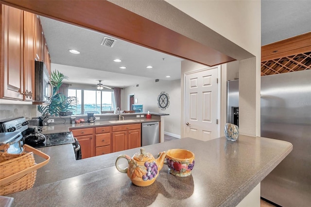 kitchen featuring ceiling fan, kitchen peninsula, and stainless steel appliances