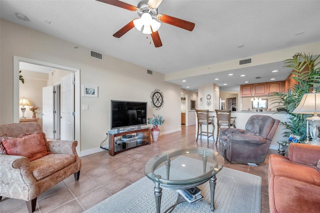 living room with ceiling fan and light tile floors