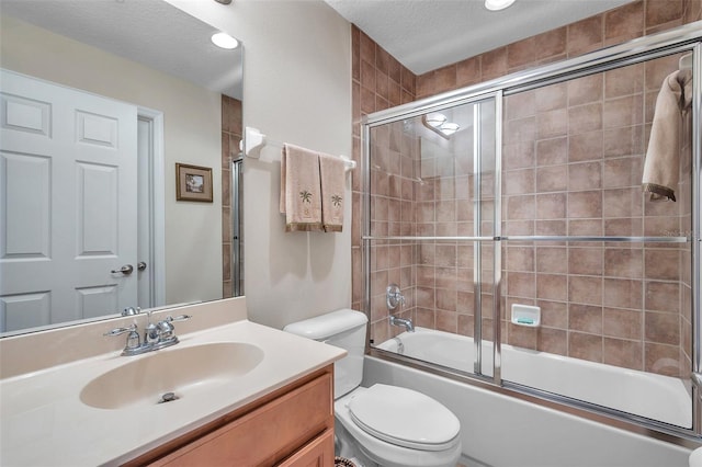 full bathroom with oversized vanity, toilet, combined bath / shower with glass door, and a textured ceiling