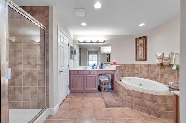 bathroom with independent shower and bath, tile floors, and vanity