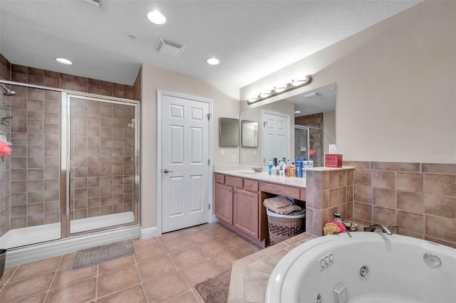 bathroom with independent shower and bath, vanity, and tile floors