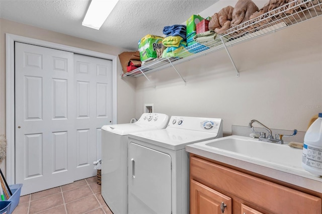 laundry area with cabinets, separate washer and dryer, a textured ceiling, washer hookup, and light tile floors