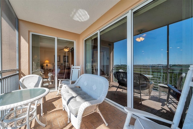 sunroom featuring ceiling fan