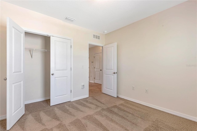 unfurnished bedroom featuring carpet flooring and a closet