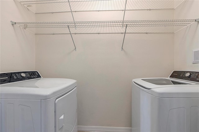 laundry room with washing machine and dryer