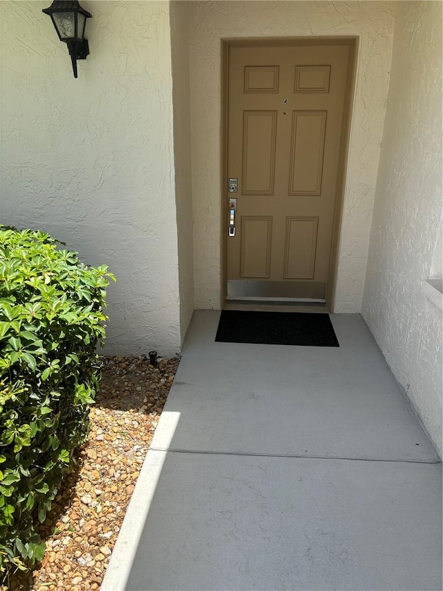 entrance to property with stucco siding