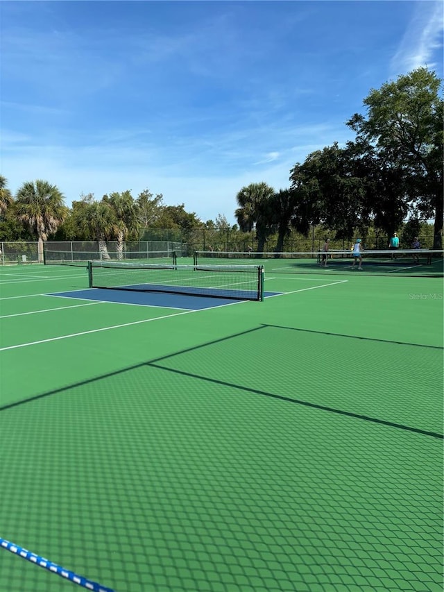 view of tennis court featuring fence