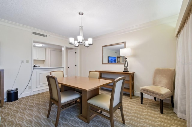 dining area featuring a textured ceiling, an inviting chandelier, and ornamental molding