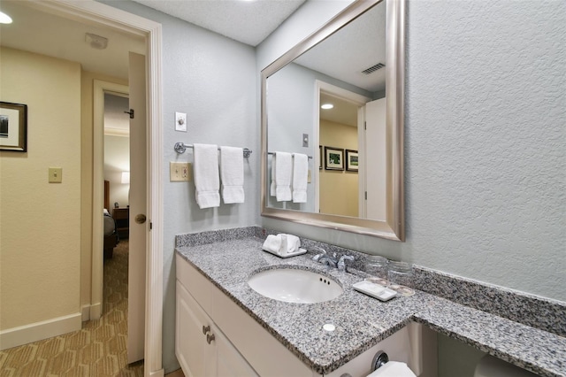 bathroom with vanity, tile floors, and a textured ceiling