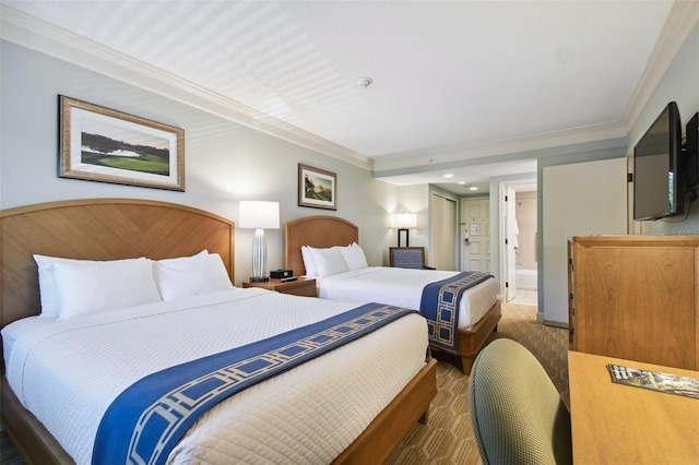 carpeted bedroom featuring crown molding and connected bathroom