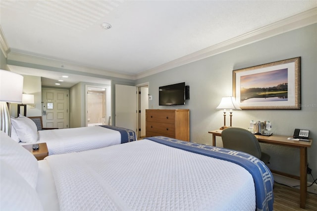 bedroom featuring ornamental molding, hardwood / wood-style floors, and ensuite bathroom