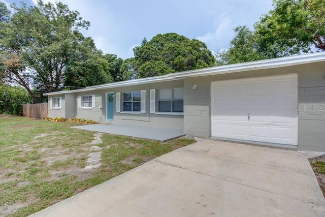 ranch-style home featuring covered porch and a garage