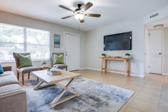 living room with ceiling fan and light tile patterned floors