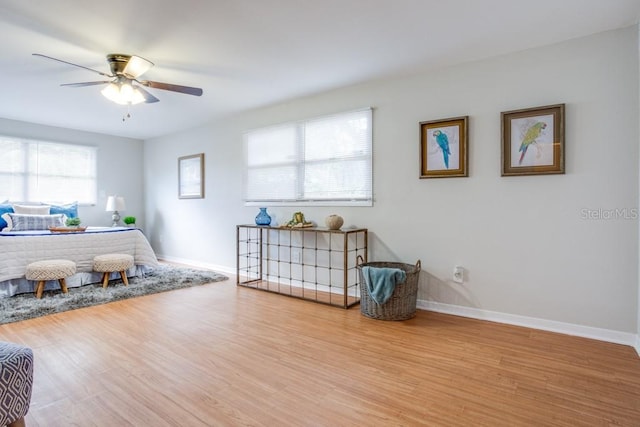 bedroom with ceiling fan and light hardwood / wood-style flooring